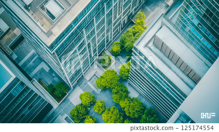 High angle view of modern office buildings surrounded by many green trees 125174554