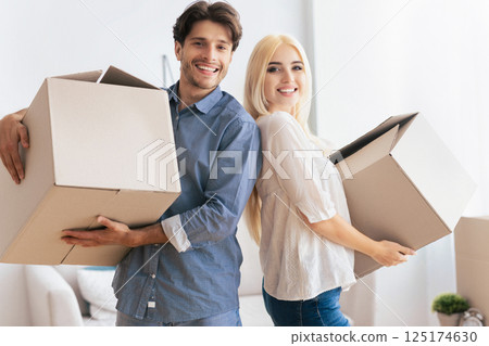 House Ownership And Relocation. Man And Woman Holding Moving Boxes Standing Back-To-Back Indoor. 125174630