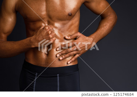 Naked Torso. Unrecognizable black man showing muscular body and six pack abs over black background with copyspace Naked Torso. Unrecognizable black man showing muscular body and six pack abs over black background with copyspace 125174684