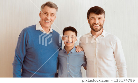 Male Family. Boy, Father And Grandfather Hugging Smiling At Camera Posing Over White Wall Indoor. Panorama 125174799