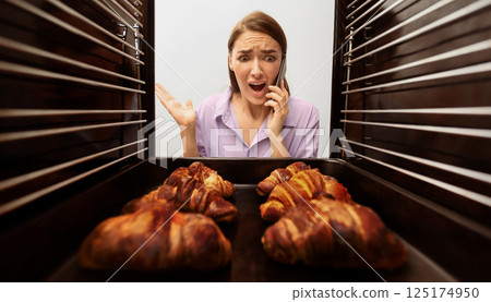 Failed recipe. Emotional woman calling for mother support, looking at baking in oven, view from inside Failed recipe. Emotional woman calling for mother support, looking at baking in oven, view from inside 125174950