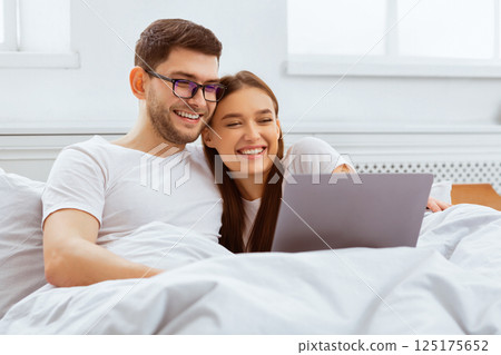 Weekend Together. Happy Couple Watching Film On Laptop Sitting In Bed At Home. Selective Focus 125175652