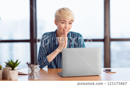 Business Success. Businesswoman Holding Hands Near Face Reading Great News Sitting At Laptop In Office. Selective Focus 125175667