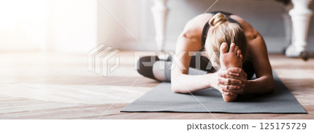 Sporty girl stretching before exercising at studio, flexible body concept, copy space 125175729