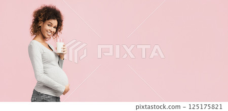 Benefits of dairy products during pregnancy. Pregnant woman holding glass of milk, free space 125175821