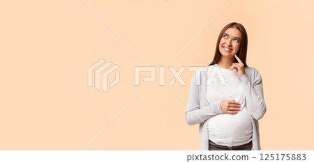 Pregnancy Needs And Wants. Cheerful Mother-To-Be Dreaming About Baby Standing Over White Background In Studio. Empty Space For Text Pregnancy Needs And Wants. Cheerful Mother-To-Be Dreaming About Baby Standing Over White Background In Studio. Empty Space For Text 125175883