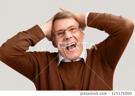 Emotional Senior Man Shouting Touching Head Posing On Gray Studio Background. Oh, No Concept Emotional Senior Man Shouting Touching Head Posing On Gray Studio Background. Oh, No Concept 125176000