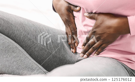 African american woman suffering from stomach ache, close up, cropped 125176012