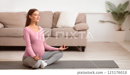 Best Age To Get Pregnant. Calm beautiful expectant woman doing yoga on the mat. Free space Best Age To Get Pregnant. Calm beautiful expectant woman doing yoga on the mat. Free space 125176018