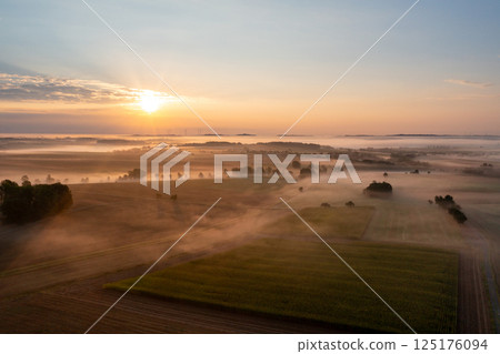 Drone aerial view of a german foggy morning in a rural scenery Drone aerial view of a german foggy morning in a rural scenery 125176094