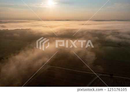 Drone view in the morning with foggy agricultural fields at golden hour 125176105