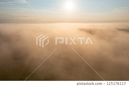 Sunrise foggy scenery at golden hour, drone aerial view 125176117