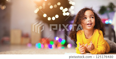 Christmas dream. Cute afro little girl writing wishlist for Xmas holidays, empty space 125176480