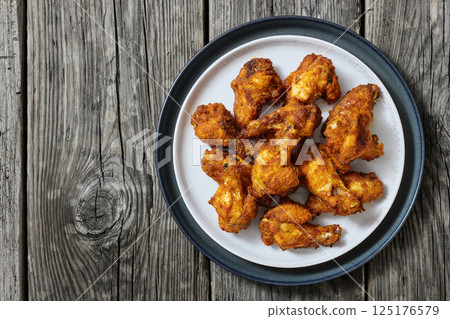 crispy fried chicken wings on a plate 125176579