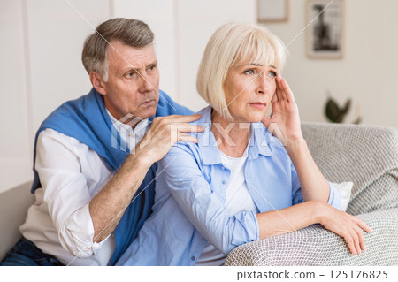 Mature husband and wife arguing, man trying to resolve family conflict at home 125176825