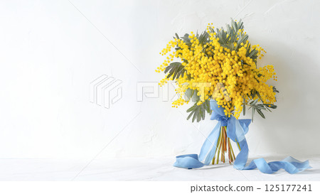 Bouquet of mimosa flowers with blue ribbon 125177241