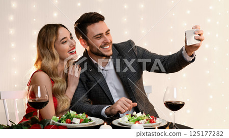 Romantic Selfie. Loving Young Couple Taking Self-Portrait While Dining In Restaurant, Celebrating Valentine's Day Together, Free Space Romantic Selfie. Loving Young Couple Taking Self-Portrait While Dining In Restaurant, Celebrating Valentine's Day Together, Free Space 125177282
