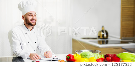 Chef Man Writing Food Recipes Working On Own Culinary Book Standing In Restaurant Kitchen Indoor. Selective Focus 125177533