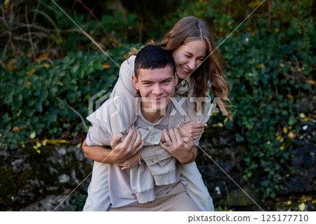 Young Cute Female Hugs Boyfriend. In Autumn Outdoor. Lovers Walking in Park. Attractive Funny Couple. Lovestory in Forest. Man and Woman. Cute Lovers in the Park. Family Concept. Happy Couple. Young Cute Female Hugs Boyfriend. In Autumn Outdoor. Lovers Walking in Park. Attractive Funny Couple. Lovestory in Forest. Man and Woman. Cute Lovers in the Park. Family Concept. Happy Couple. 125177710