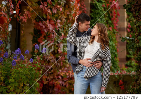 Young Cute Female Hugs Boyfriend. In Autumn Outdoor. Lovers Walking in Park. Attractive Funny Couple. Lovestory in Forest. Man and Woman. Cute Lovers in the Park. Family Concept. Happy Couple. 125177799