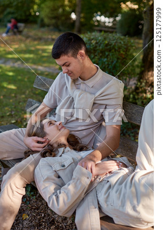 Young Cute Female Hugs Boyfriend. In Autumn Outdoor. Lovers Walking in Park. Attractive Funny Couple. Lovestory in Forest. Man and Woman. Cute Lovers in the Park. Family Concept. Happy Couple. 125177999