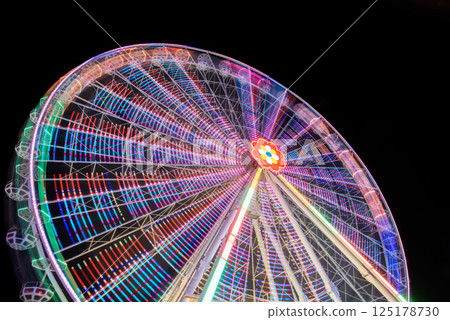 Colorful Ferris Wheel Illuminated at Night Colorful Ferris Wheel Illuminated at Night 125178730
