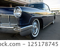 Front Side View of a Dark Blue Vintage Car with Chrome Details 125178745