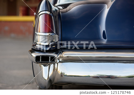 Rear Detail of a Dark Blue Vintage Car with Chrome Bumper Rear Detail of a Dark Blue Vintage Car with Chrome Bumper 125178746