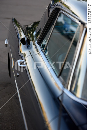 Dark Blue Vintage Car Detail with Reflections Dark Blue Vintage Car Detail with Reflections 125178747