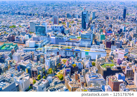 Tokyo cityscape in Japan: Ikebukuro Station and the transforming West Exit area (back), with skyscrapers emerging Tokyo cityscape in Japan: Ikebukuro Station and the transforming West Exit area (back), with skyscrapers emerging 125178764