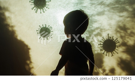A young child stands in silhouette, looking up at ominous virus illustrations against a glowing background. This moment captures the child's curiosity and the serious nature of health concerns today. 125179041