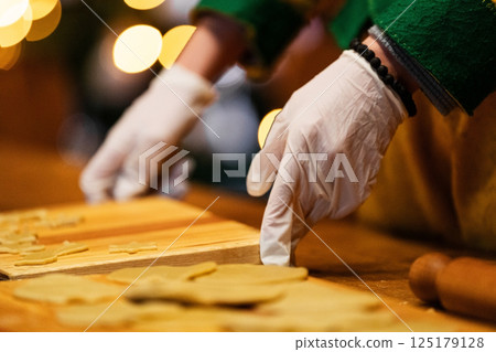 Hands Preparing Christmas Cookies with Gloves 125179128