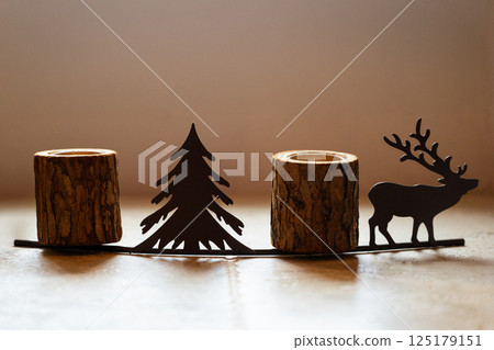 Rustic wooden candle holders with reindeer and tree design 125179151