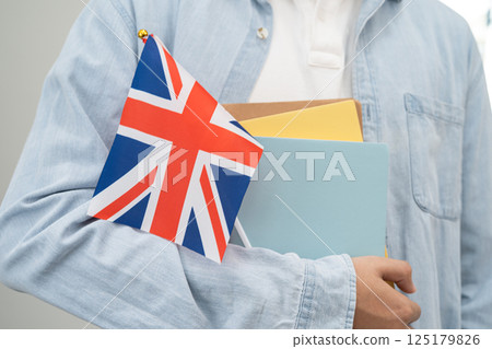 Learn English language, Asian teenage student hold book with flag in course at school. Learn English language, Asian teenage student hold book with flag in course at school. 125179826