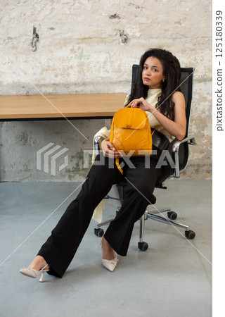 A Chic Outfit Featuring a Bright Yellow Backpack Paired with Stylish and Trendy Footwear 125180339