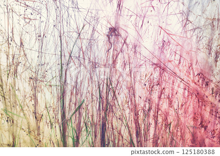Blurred photo of grass and plants behind the foil, abstract background. Blurred photo of grass and plants behind the foil, abstract background. 125180388