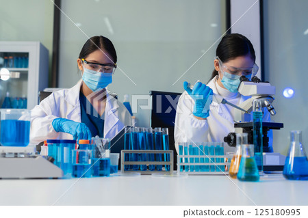 Glass vial, pipette and scientist in laboratory for medical study, research or experiment. Test tube, dropper and professional person with chemical liquid for pharmaceutical innovation. Glass vial, pipette and scientist in laboratory for medical study, research or experiment. Test tube, dropper and professional person with chemical liquid for pharmaceutical innovation. 125180995