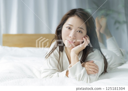 A woman lying on the bed A woman lying on the bed 125181304