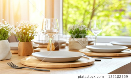 Modern Easter breakfast table Natural wood texture, white plates, fresh potted herbs, near window. 125182569