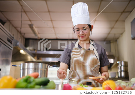 Focused chef carefully a gourmet sandwich in a professional kitchen with fresh ingredients in view Focused chef carefully a gourmet sandwich in a professional kitchen with fresh ingredients in view 125182736
