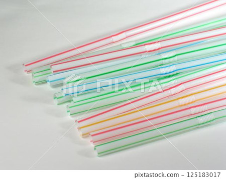 Colored straws over white background Colored straws over white background 125183017