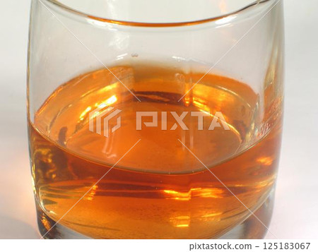 Glass of whiskey on white background 125183067