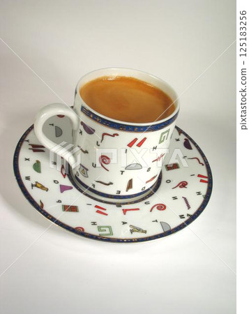 A cup of coffee on a table close view background A cup of coffee on a table close view background 125183256