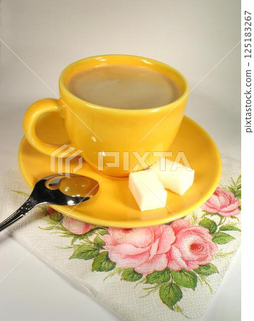 A cup of coffee on a table close view background A cup of coffee on a table close view background 125183267