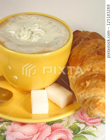 A cup of coffee on a table close view background A cup of coffee on a table close view background 125183269