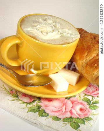 A cup of coffee on a table close view background 125183270
