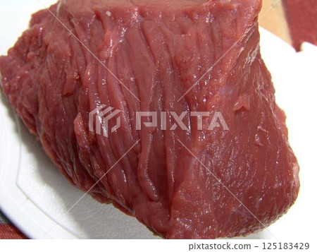 Raw uncooked meat close view background Raw uncooked meat close view background 125183429