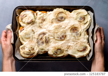 Homemade cinnabons with cinnamon and cream cheese. 125183787