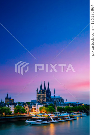 Great St. Martin Church And Dom In Cologne At Evening With Reflection In River Rhine, Germany. Cologne. Great St. Martin Church And Dom In Cologne At Evening With Reflection In River Rhine. Sunset 125183964