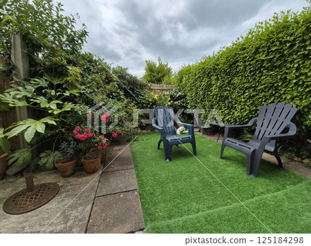Outdoor Scene with Flowerpots and Furniture under a Cloudy Sky Outdoor Scene with Flowerpots and Furniture under a Cloudy Sky 125184298